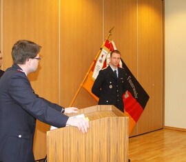 Vorsitzender des Kreis&shy;feuerwehr&shy;verbandes Spree-Neie e.V. verliest die Urkunde zu Auszeichnung des Kam. Martin Gloeckner